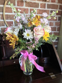Fresh seasonal flowers professionally arranged in a glass vase